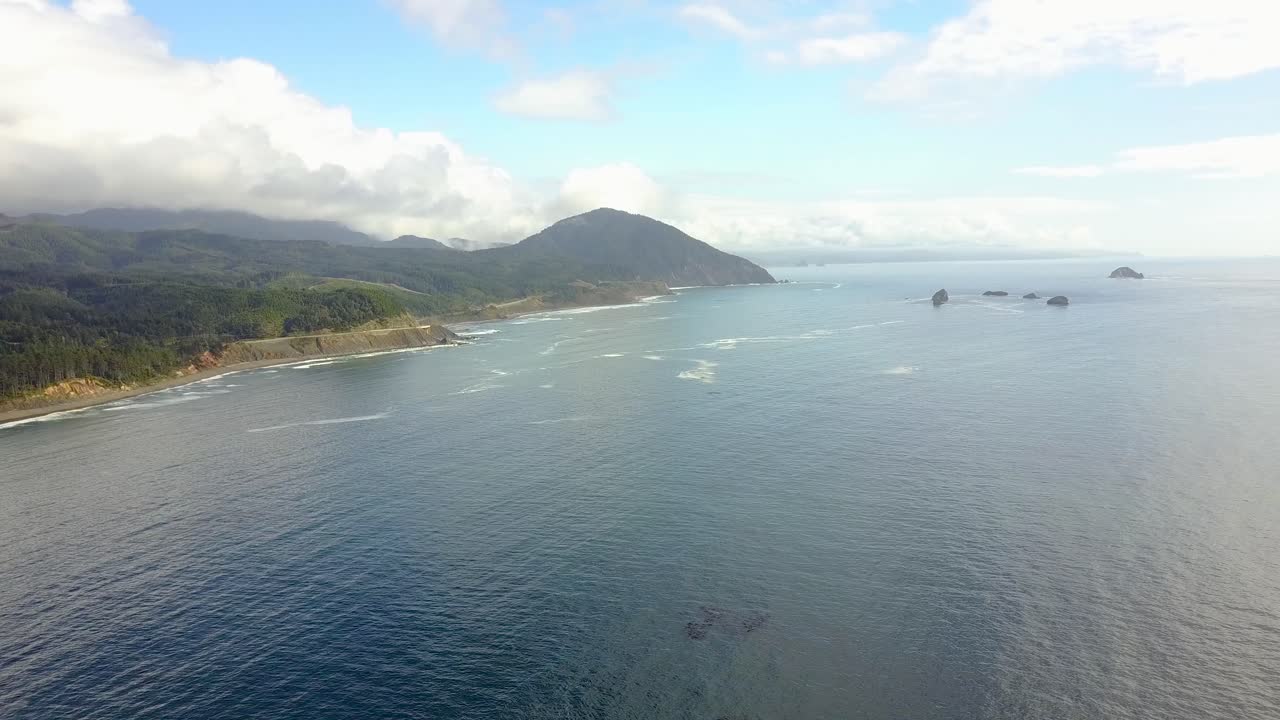 A slow and steady aerial view overlooking a dramatic coastline.