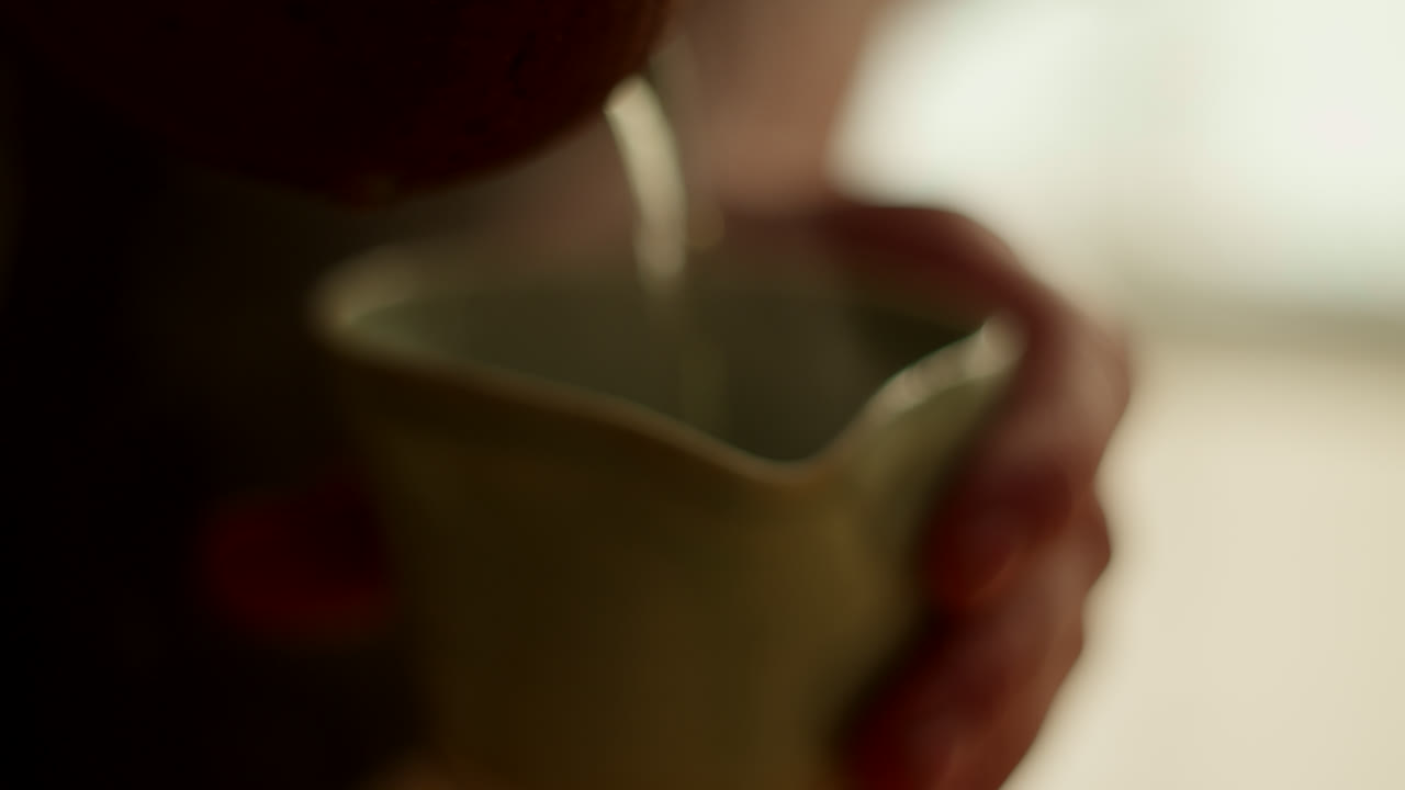 Person Pouring Tea