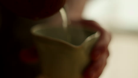 person pouring tea