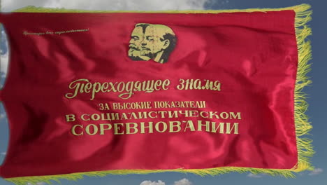 flag depicting marx and lenin flies in a brisk breeze in slow motion