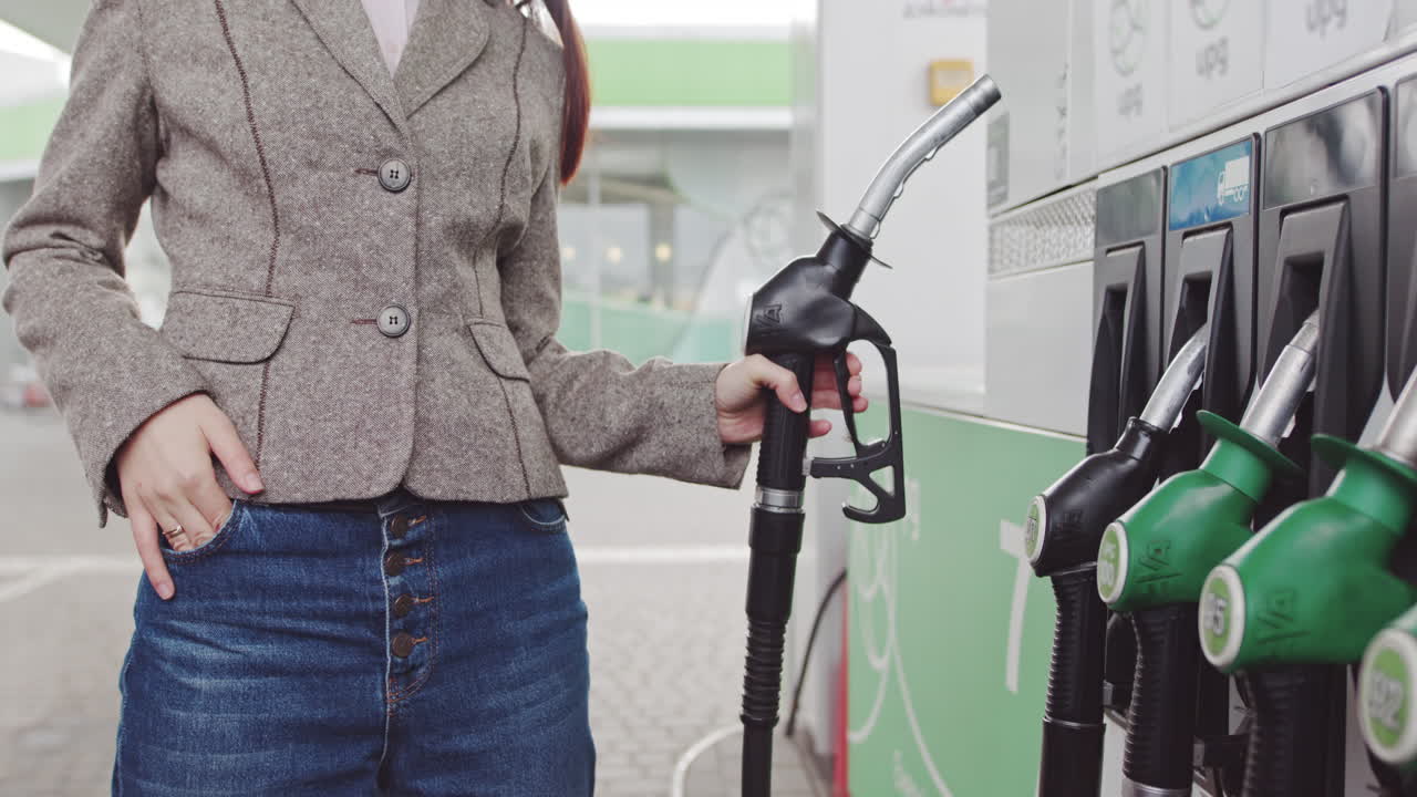 Woman Filling Up Her Car at a Gas Station