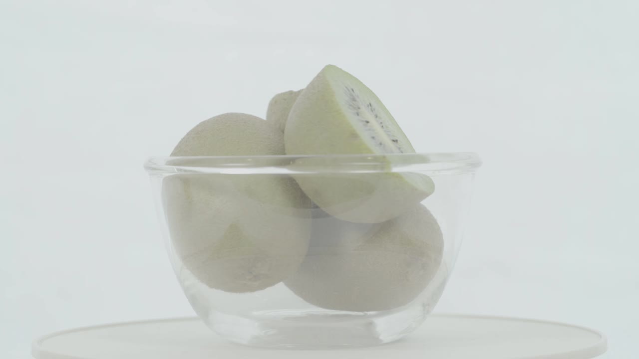 kiwis verdes frescos y maduros en cuenco giratorio, no clasificados