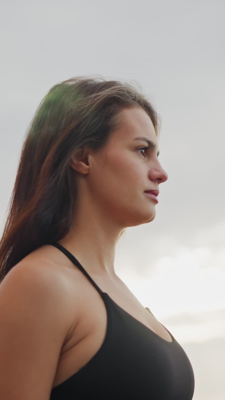 Athlete walking slowly under sunny atmosphere, showcasing calm and focused demeanor, background features a clear sky, ideal for fitness content or serene outdoor walking activity