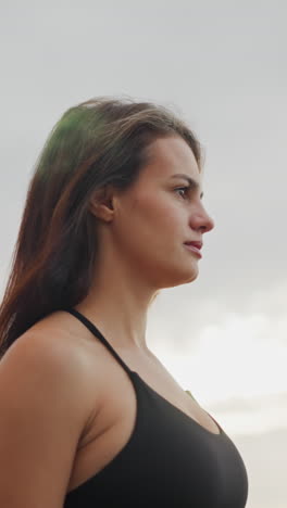 athlete walking slowly under sunny atmosphere, showcasing calm and focused demeanor, background features a clear sky, ideal for fitness content or serene outdoor walking activity