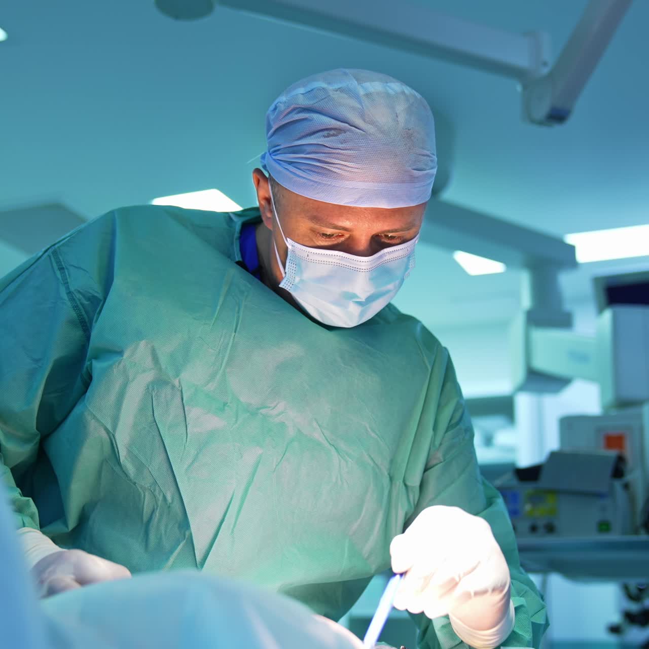 Concentrated plastic surgeon marks patient's body. Professional doctor in medical uniform and mask prepares patient for liposuction procedure in surgical room