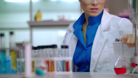 female lab worker in science laboratory. lab researcher working with liquid