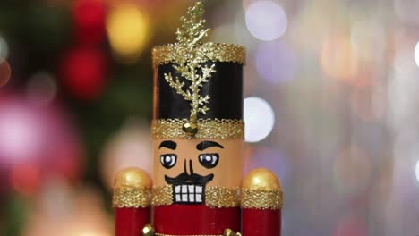 detail of glitter toy soldier nutcracker on bokeh christmas background