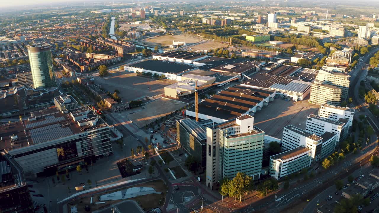 The City Of Utrecht With The Empty Central Railway Train Station During The Coronavirus Lockdown In The Netherlands. - aerial pan up