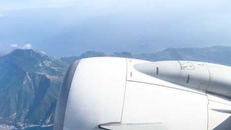 Jet-engine-over-mountainous-landscape-during-flight