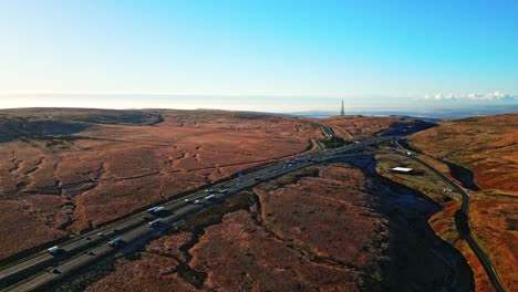 Moving-Aerial-Moorland-View-of-Saddleworth-moor,-the-M62-motorway-and-Ripponden-road