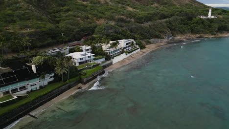 Aerial---Forward-panning-shot-on-waterfront-houses-in-serene-green-neighborhood