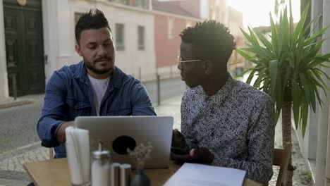 Freelancers-with-laptop-and-smartphone-discussing-work