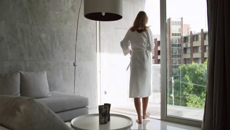 Caucasian-woman-standing-alone-in-hotel-room