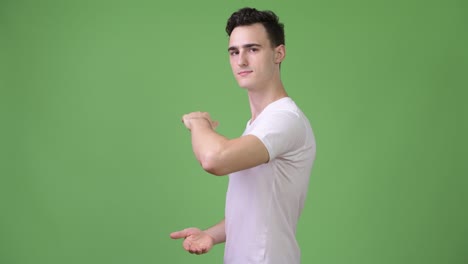 young handsome man showing something