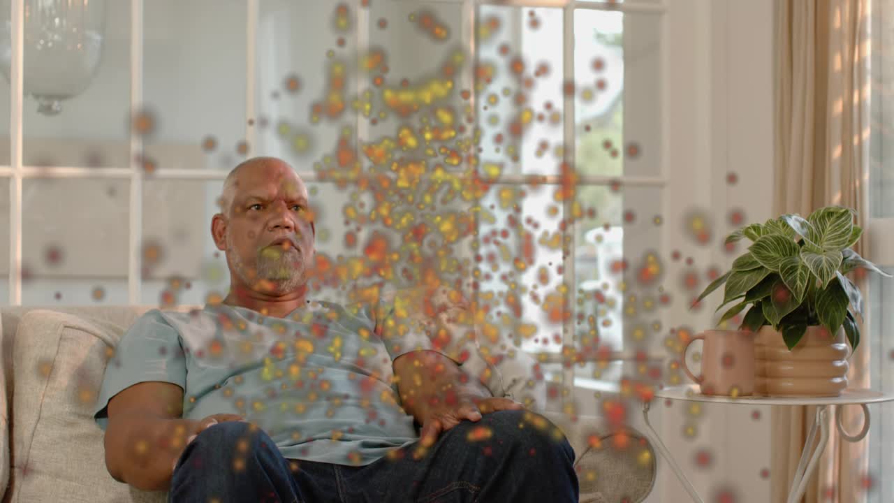 Senior man reacting, shielding face in lounge, animated particles appearing, causing health concern