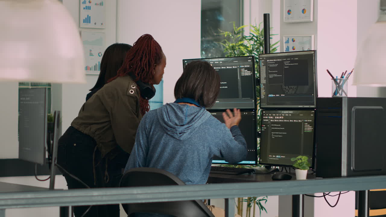 Diverse team of database admins analyzing source code and comparing data script