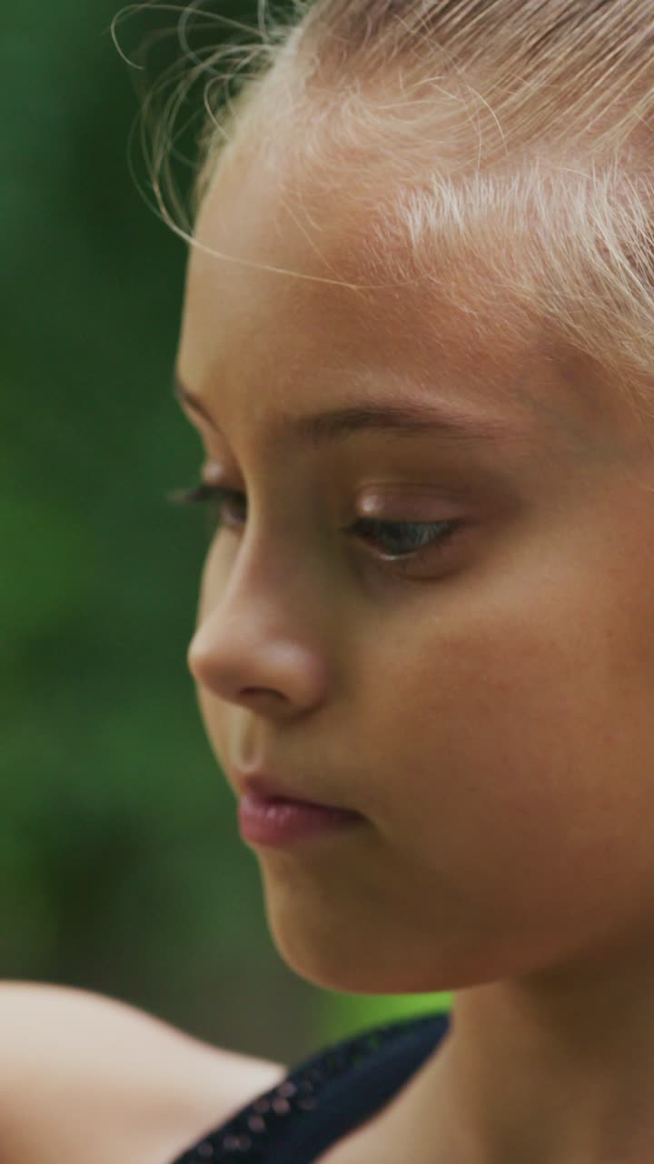 A Serene Moment Captured: A Young Girl's Profile Expression and Poise Amidst a Natural Background, Evoking Innocence and Curiosity