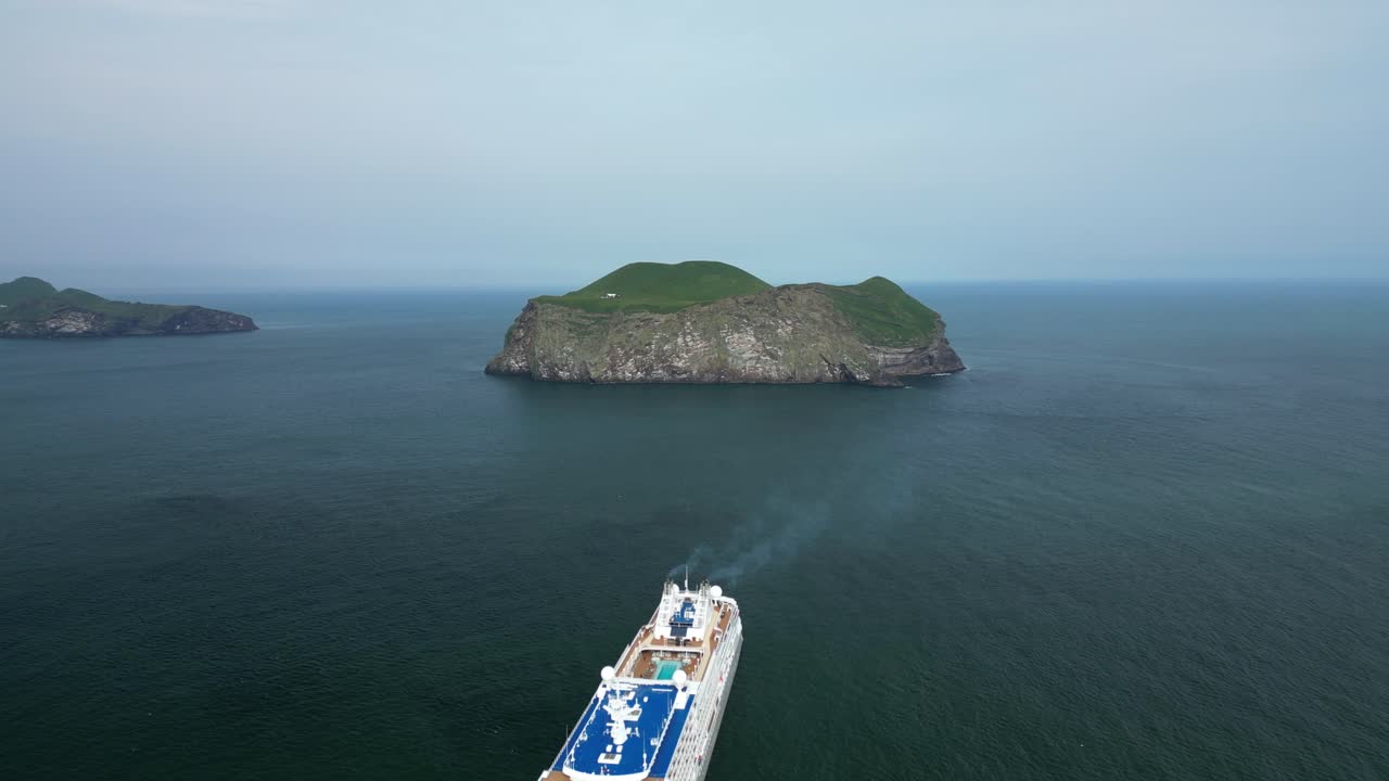 Cruise ship departing from remote island based in the Atlantic ocean, near Iceland&acute;s shore