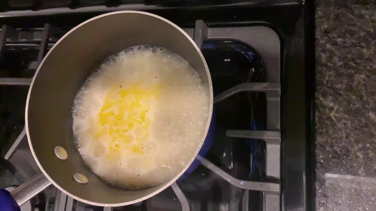 Riso che bolle in una pentola con acqua.