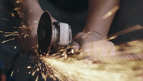 worker man using electric wheel grinding and cutting on steel structure