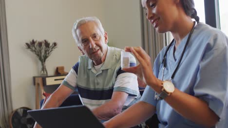 animation of happy biracial female doctor talking about medicines with caucasian senior man