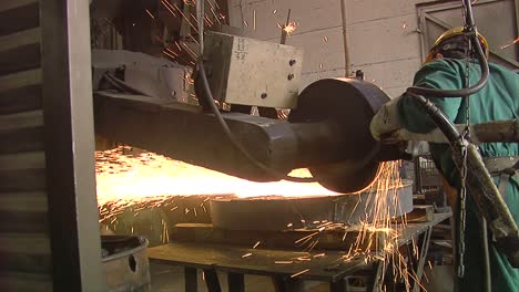 worker using industrial grinder