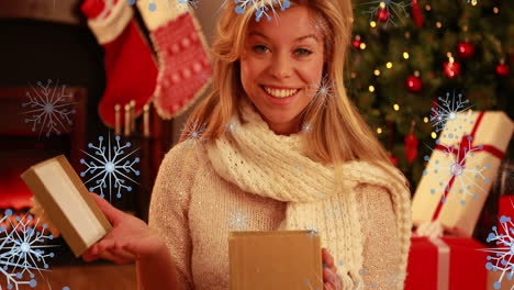 animation of snow falling over caucasian woman with christmas presents