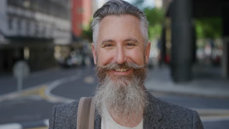 portrait of handsome man with beard smiling happy enjoying successful urban lifestyle commuter wearing stylish fashion in city street background slow motion