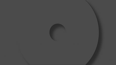 animation of grey circles and crosses spinning on grey background