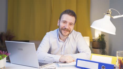 home office worker man talking facetime looking at camera.