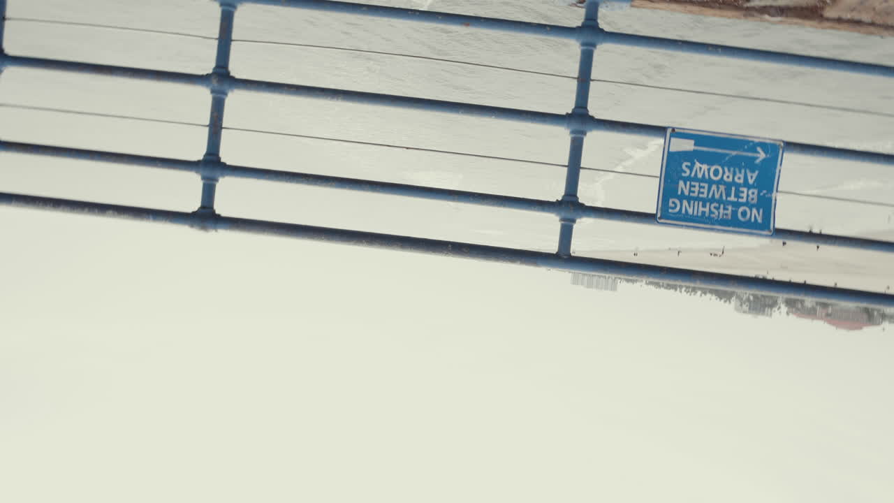 Rolling shot of railing at Santa Monica Pier California Cloudy Day