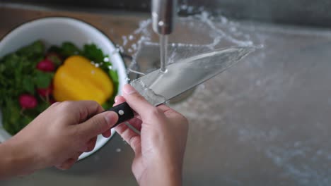 a chef washes a knife