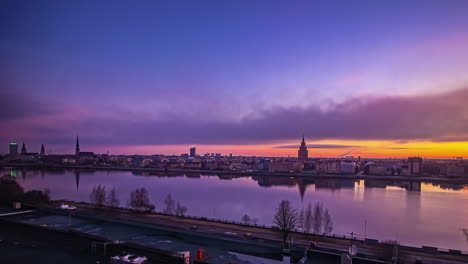 awesome time-lapse going from day to night and the city of riga in latvia being reflected in the water