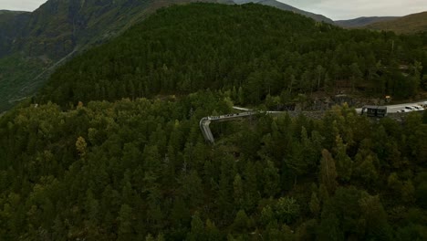 drone flies over the stegastein viewing platform in norway under cloudy skies