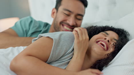 Laugh,-bedroom-fun-and-silly-couple-lying-in-bed