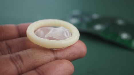 close-up of a condom held in a hand