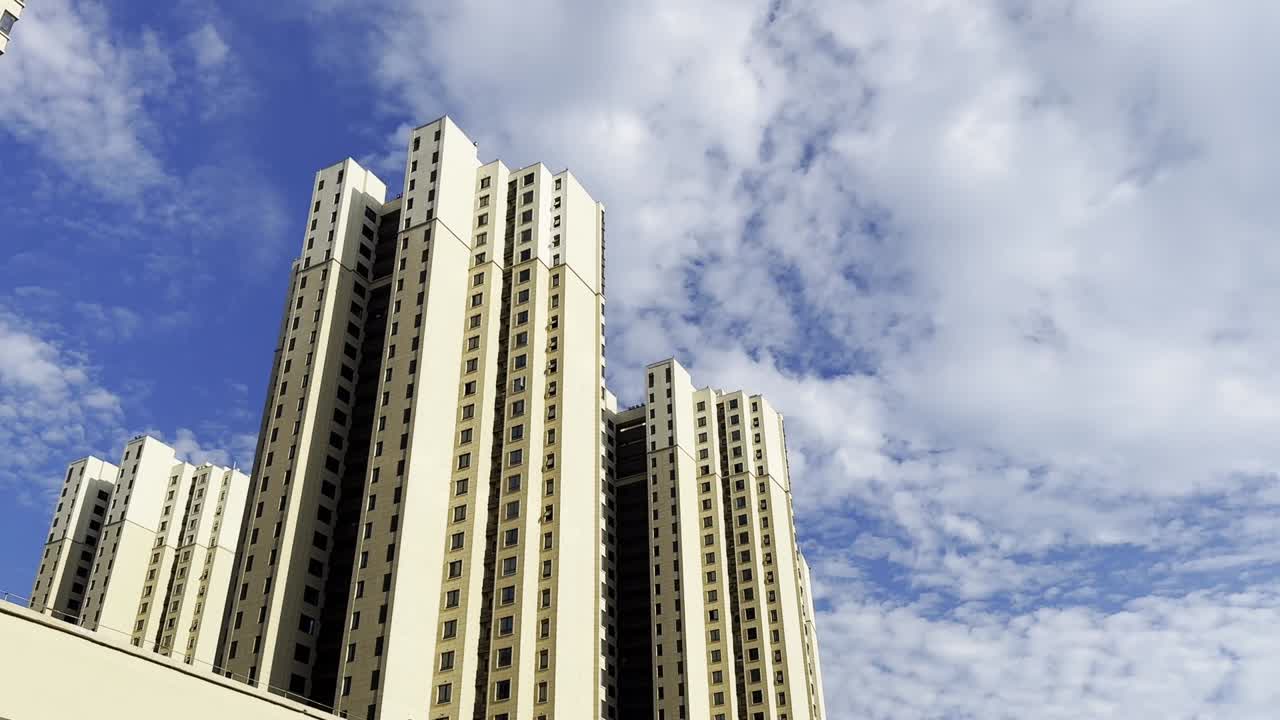 Tall Residential Buildings Under a Blue Sky