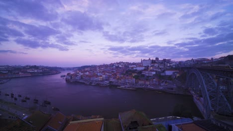 porto, portugal, unesco heritage site, old city houses and douro river during sunrise, blue hour with 3 birds flying by