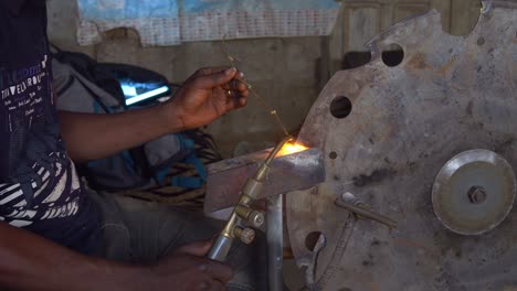 Closeup-Shot-Hands-of-Black-African-American-Worker-Welding-a-Metal-Saw-Slowmo