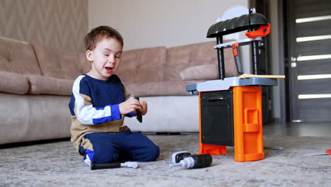 kid playing with toy kitchen. a young boy explores his toy kitchen set while sitting on the floor in a cozy living room, experimenting with utensils