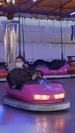 people enjoying bumper car rides at an amusement park