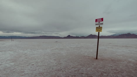 empty salt flat with no trespassing sign