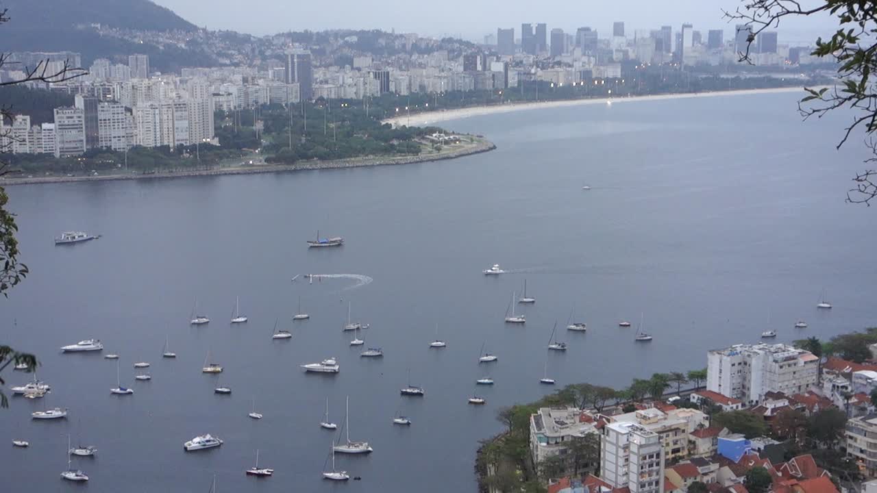 Boats And Yachts On Guanabara Bay Near Small Beach Of Urca In Rio de Janeiro Brazil. aerial tilt-down