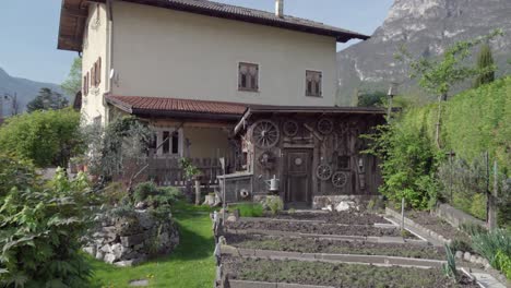 zooming out of a garden, a shed and a house in spring, kurtinig - cortina, south tyrol, italy