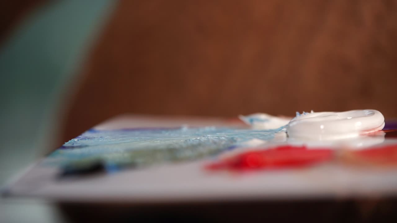 Artist Painting with Brush on Palette