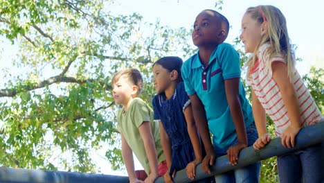 Kids-pointing-towards-a-distant-in-the-playground-4k