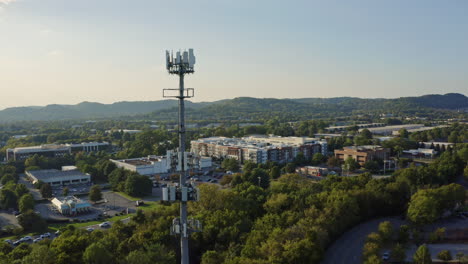 aerial view passing by 5g cell phone radio communications tower, 4k