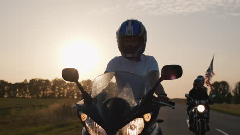 young people on high-speed motorcycles ride on the highway 3