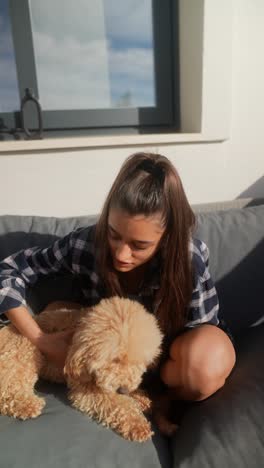 young woman and her dog on a patio