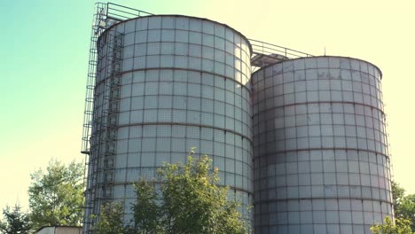 a pair of grain silos - aerial view in sunny day